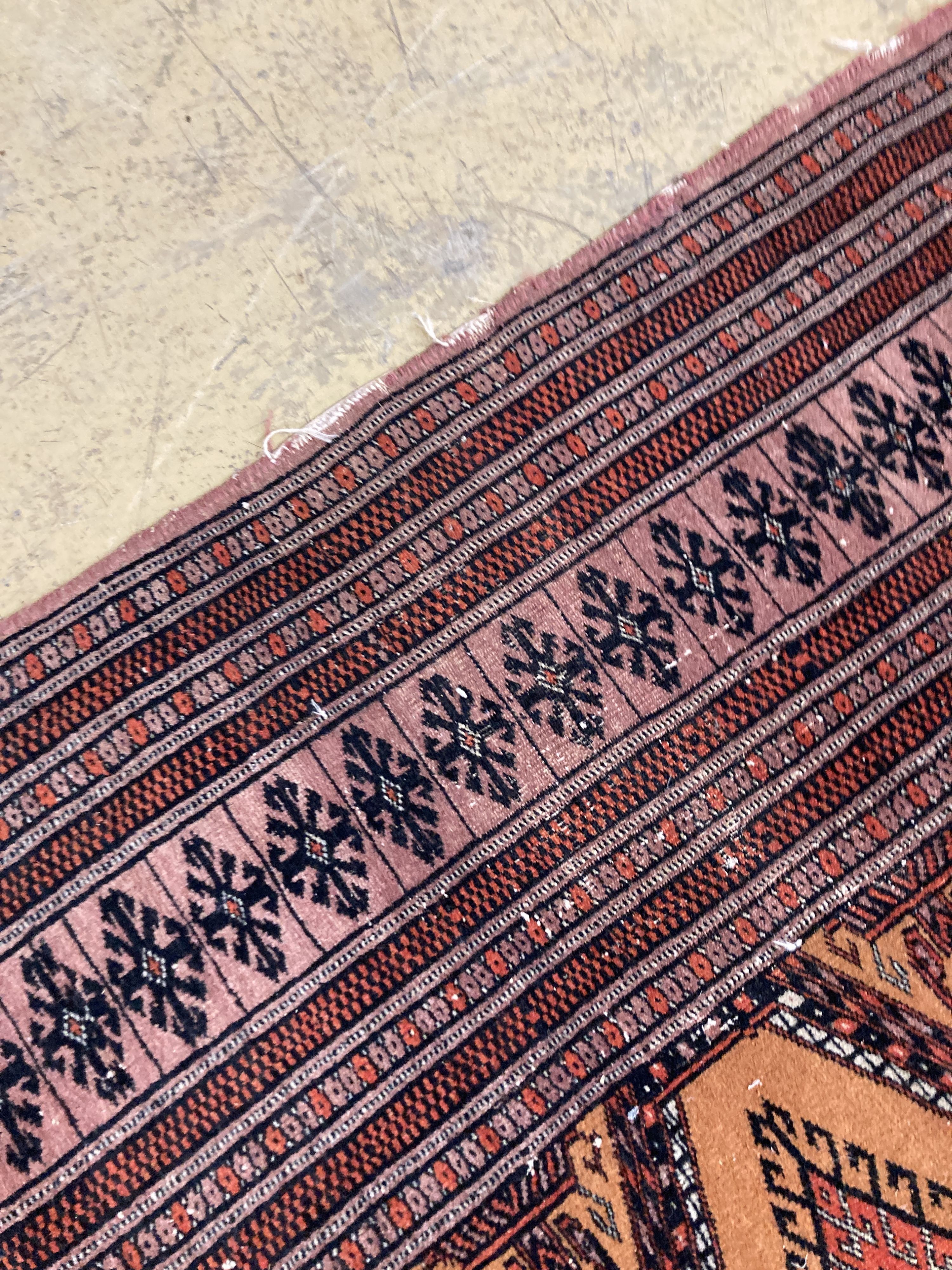 A Bokhara orange ground rug 198 x 125 cms, a smaller Anatolian flat weave rug and Bokhara prayer mat.